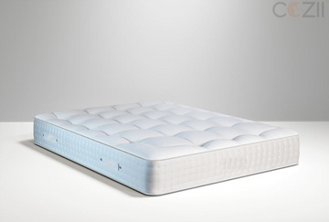 A white mattress with the Cozi logo on a clean surface.